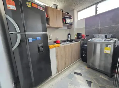 a kitchen with a stainless steel refrigerator and a dishwasher at Acogedor apto laureles estadio in Medellín