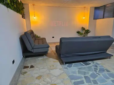 a living room with a couch and a chair at Acogedor apto laureles estadio in Medellín