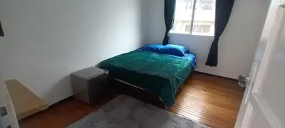 a small bedroom with a bed and a window at habitaciones amobladas la estrella in Manizales