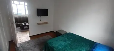 a bedroom with a bed and a tv on the wall at habitaciones amobladas la estrella in Manizales