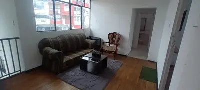 a living room with a leather couch and a table at habitaciones amobladas la estrella in Manizales