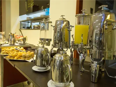 a kitchen with a counter with a bunch of equipment at Hotel Dorado La 70 in Medellín