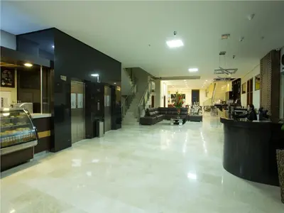 a lobby of a building with people sitting in it at Hotel Dorado La 70 in Medellín