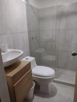 a bathroom with a toilet and a sink and a shower at 44-20 Tiny Loft in Medellín