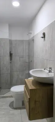 a bathroom with a sink and a toilet at 44-20 Tiny Loft in Medellín