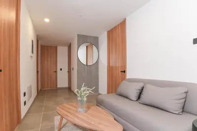 a living room with a couch and a table at Metropolitan Living by HOUSY in Medellín