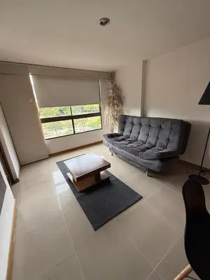 a living room with a couch and a coffee table at Mirador pueblito Paisa-Tipo loft in Medellín