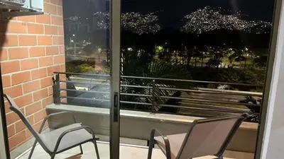 two chairs sitting on a balcony with a window at Mirador pueblito Paisa-Tipo loft in Medellín