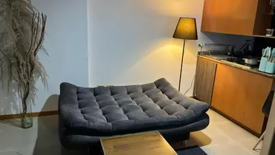a blue tufted couch in a living room at Mirador pueblito Paisa-Tipo loft in Medellín