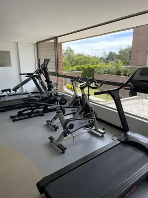 a gym with three cardio bikes and a large window at Suite Casa Grande in Rionegro
