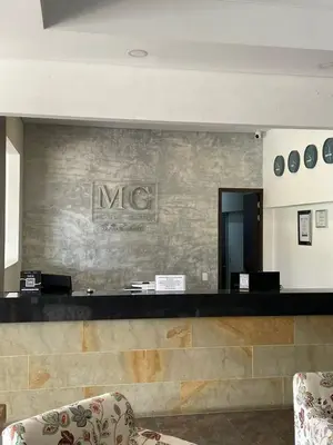 a lobby with a mrc sign on a wall at Suite Casa Grande in Rionegro