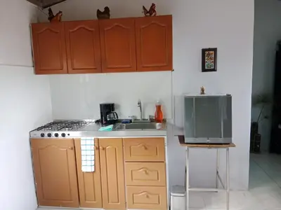 a small kitchen with a sink and a tv at Casa Campestre en Guarne in Guarne