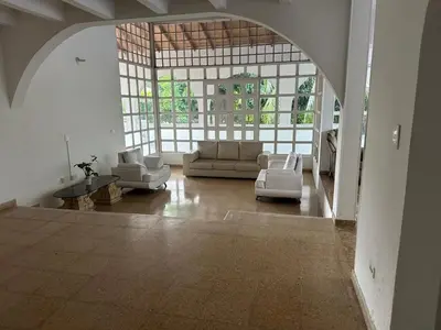 a large living room with couches and a large window at Casa campestre con piscina, jacuzzi y bbq in La Dorada