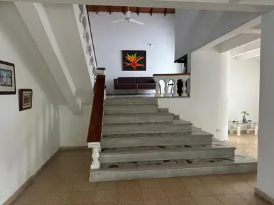 a staircase in a living room with a couch at Casa campestre con piscina, jacuzzi y bbq in La Dorada