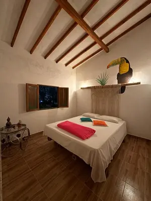 a bedroom with a large bed in a room at Mamaquilla Grupal Glamping in Jardin