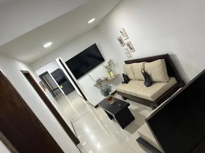 a living room with a couch and a tv at 9 Bedrooms house in Medellín