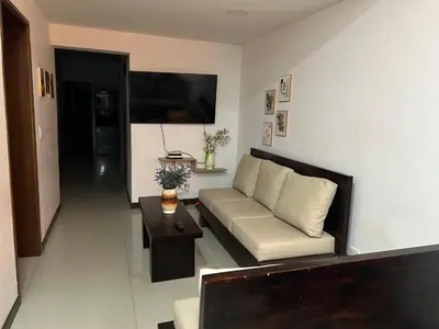 a living room with a couch and a table at 9 Bedrooms house in Medellín