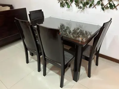 a dining table with two chairs and a glass top at 9 Bedrooms house in Medellín