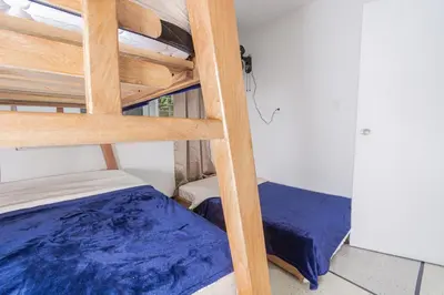 a room with two bunk beds and a ladder at Hostal Bendito, central y cómodo in Medellín
