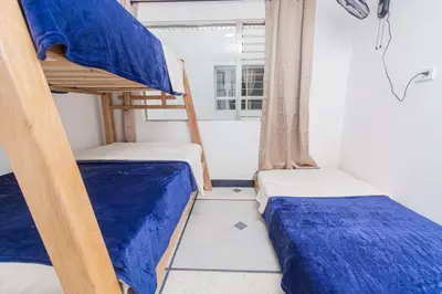 two bunk beds in a room with a window at Hostal Bendito, central y cómodo in Medellín