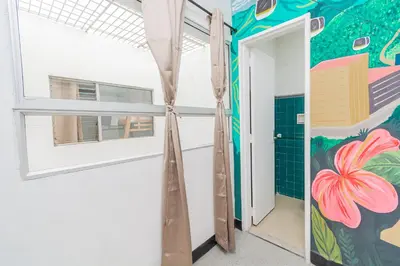 a room with a window and a painting on the wall at Hostal Bendito, central y cómodo in Medellín
