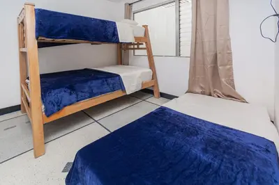 two bunk beds in a room with a window at Hostal Bendito, central y cómodo in Medellín
