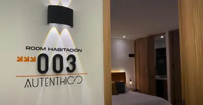 a hotel room with a sign on a wall at Autenthico Local Stay Hotel Envigado in Envigado