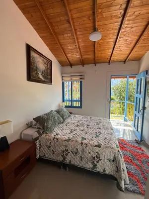 a bedroom with a bed and a wooden ceiling at El Refugio in Copacabana