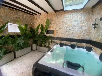 a bathroom with a large tub with plants at El Refugio in Copacabana