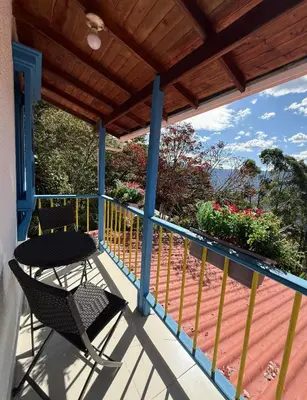 a patio with a table and chairs on a balcony at El Refugio in Copacabana
