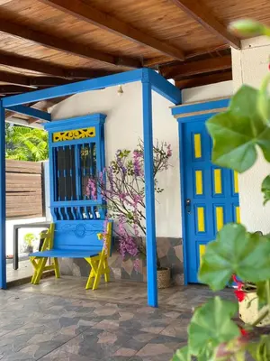a blue door and a yellow chair on a patio at El Refugio in Copacabana