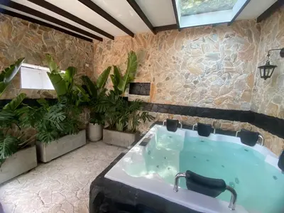 a bath tub in a room with plants at El Refugio in Copacabana