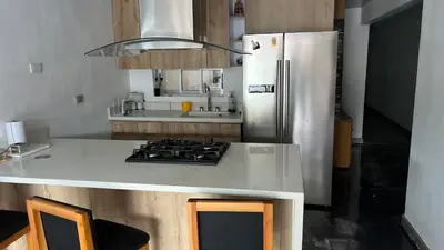 a kitchen with a refrigerator and a counter top at Apartamento Simón Bolívar in Itagüí