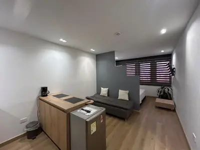 a living room with a couch and a table at Elegante lugar a pasos del metro in Medellín