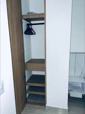 a door leading into a closet with shelves and a light at Aparta- estudio de lujo con jacuzzi in Medellín