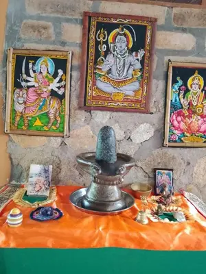 a room with paintings on the wall and a table with a statue at Shiva's Temple in San Carlos