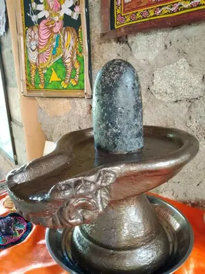 a vase sitting on a table with a hat on it at Shiva's Temple in San Carlos