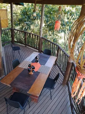 a wooden table and chairs on a deck at Shiva's Temple in San Carlos