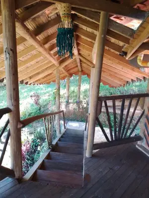 a wooden deck with a wooden roof and stairs at Shiva's Temple in San Carlos