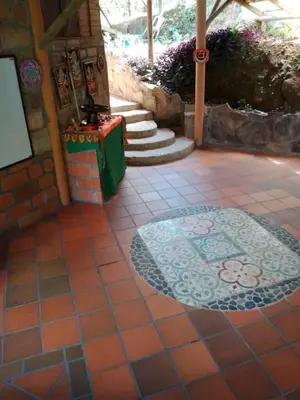 a patio with a tile floor with a rug at Shiva's Temple in San Carlos