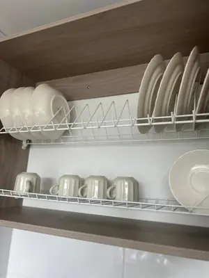 a bunch of plates and bowls on a shelf at Central, Universidades y Centro Comercial in Manizales