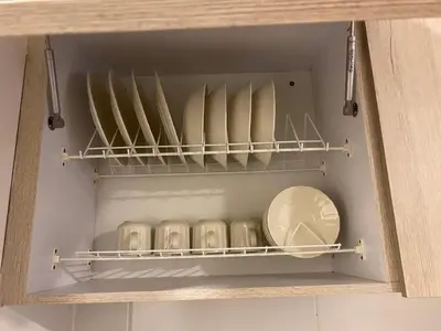 a drawer of a cupboard with plates and pans at Central, Universidades y Centro Comercial in Manizales