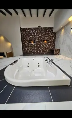 a bathroom with a white bath tub in a room at Casa de campo El Jaguar in San Jerónimo