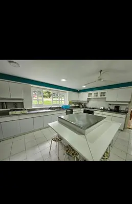 a large kitchen with a table in the middle of it at Casa de campo El Jaguar in San Jerónimo
