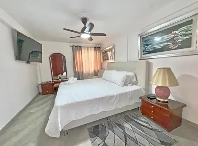 a bedroom with a bed and a ceiling fan at Apartamento Stay Medellín Laureles in Medellín