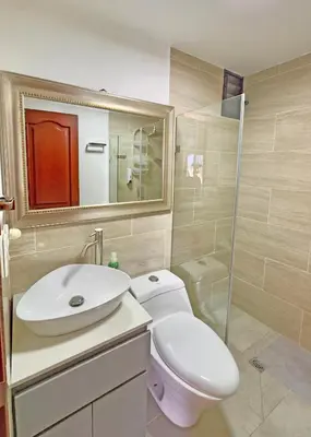 a bathroom with a toilet and a sink and a shower at Apartamento Stay Medellín Laureles in Medellín