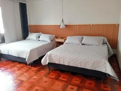 two beds sitting next to each other in a room at Casa Frailejón Manizales in Manizales