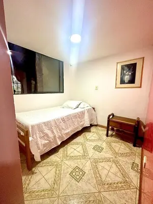 a bedroom with a bed and a tv on the wall at Apartamento en Belén la palma medellin in Medellín
