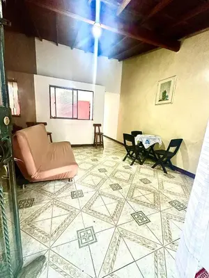a living room with a couch and chairs on a tiled floor at Apartamento en Belén la palma medellin in Medellín