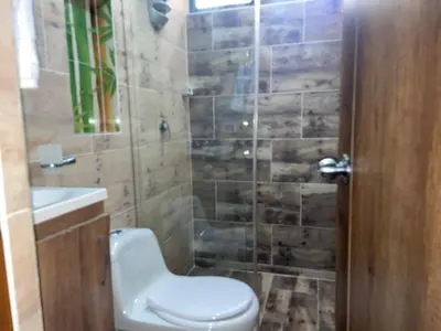 a bathroom with a toilet and a sink and a shower at Loft Belén cerca a Unicentro y Unidad Deportiva Belén Sofá cama in Medellín